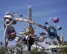 a large metal structure with many different objects on it's face and in front of a blue sky