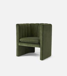 a green chair with a curved back and armrest