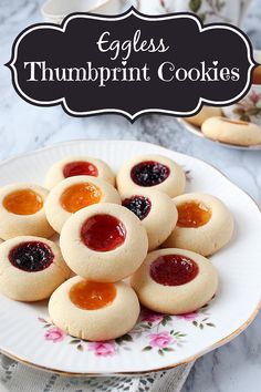 eggless thumbprint cookies on a plate with jam