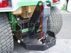 the rear end of a green truck with its brake assembly removed