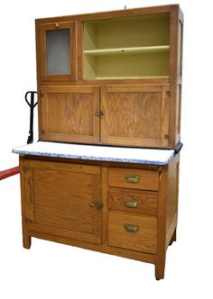 an old fashioned wooden cabinet with marble top