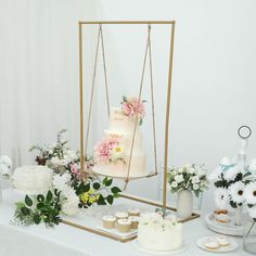 a table topped with lots of cakes and flowers