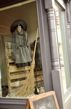 a broom and sign in front of a store window