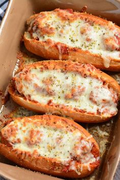 baked stuffed sweet potatoes with cheese and sauce in a casserole dish, ready to be eaten