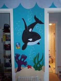 an image of a room decorated in the theme of orca whale and corals