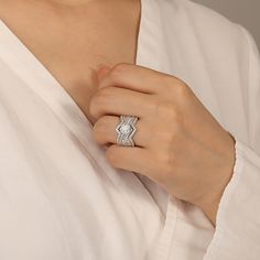 a woman wearing a diamond ring on her finger