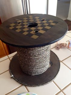 a spool of thread sitting on top of a table