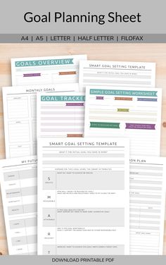 the goal planning sheet is shown on top of a wooden table
