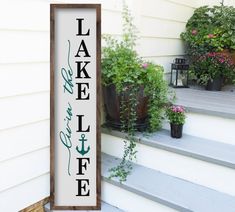 a sign on the side of a house that says lake view inn and coffee next to potted plants