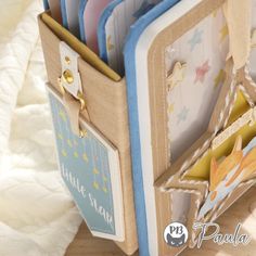 a close up of an open book on a table with papers and magnets in it