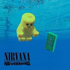 a lego toy floating in the water next to a hundred dollar bill with a string attached