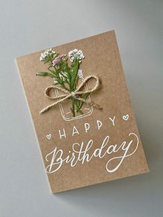 a birthday card with flowers in a mason jar