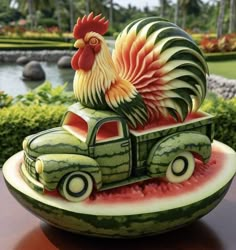 a watermelon sculpture of a truck with a rooster on it