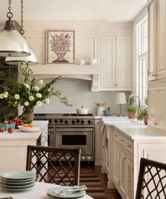 a kitchen filled with lots of white furniture