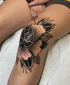 a woman's leg with a flower tattoo on it