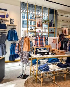 a clothing store with mannequins and shirts on display