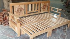 a wooden bed frame sitting on top of a stone floor