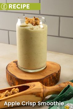 an apple crisp smoothie in a glass on a wooden stand