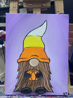 a painting of a bearded gnome wearing a yellow and orange hat on purple background with paintbrushes