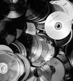 black and white photograph of many cds stacked on top of each other