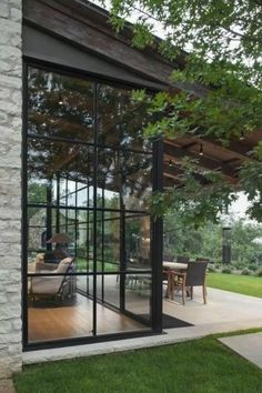 an open patio with glass doors and furniture