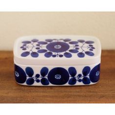 a blue and white box sitting on top of a wooden table