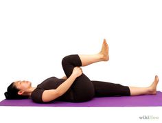 a woman is doing yoga on a purple mat