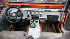 the interior of an old car with steering wheel and dashboard