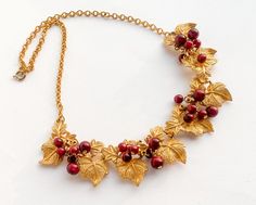 ~ 1950s beautiful gold grapes leaves necklace ~ Brushed gold intricate leaves ~ Dark red bead balls on each leaf ~ Very nice gold metal backing ~ Excellent necklace Length- 18.5" (47 cm) Width- 1"  (2.54 cm) Additional Vintage Jewelry in our sister shop Glenna's Jewels: http://glennasjewels.etsy.com More Incredible Vintage: http://glennasvintageshop.etsy.com Instagram @glennas_clothing Facebook https://www.facebook.com/glennasclothing Grapes Leaves, Leaves Necklace, Leaf Necklace, Choker Necklaces, Red Bead, Grape Leaves, Dark Red, Gold Metal, Grapes