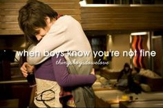 the boy is hugging his friend in front of the kitchen counter and stove with words on it