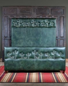 a green leather headboard sitting on top of a rug