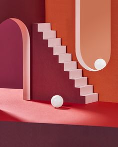 an image of a staircase with balls on the floor and in the background, there is a red wall