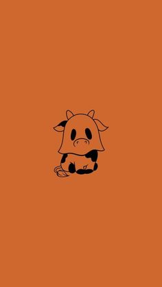 an orange background with a black and white cow sitting on it's back legs