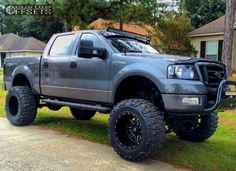 a gray truck parked in front of a house