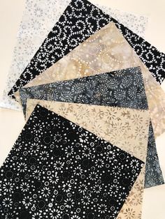 several different types of fabric laid out on top of each other, including black and white