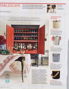 an article in a magazine about the kitchen and dining room furniture with red cupboards