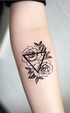 a black and white rose tattoo on the arm