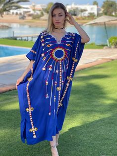 This beautiful Kaftan with the Siwa inspired embroidery is a bohemian and flashy dress that will catch everyone's eyes. This Kaftan is ideal to wear for any casual occasion. Whether taking a trip down the shopping lane, or home-based kitty parties, or about anything else, wearing this dress will make you feel classy and comfortable. Fabric : 70% Egyptian Cotton; 30% Polyester. Size : Free sized dress. This Kaftan is a free sized dress meaning that it comes in one size only that fits any size fro Bohemian Tunic Kaftan For Festivals, Blue Cotton Kaftan For Vacation, Blue Cotton Kaftan For The Beach, Blue Cotton Kaftan In Free Size, Bohemian Kaftan With Chikankari Embroidery For Summer, Bohemian Kaftan With Kimono Sleeves And Floral Embroidery, Blue Free Size Cotton Kaftan, Blue Bohemian Dress With Kimono Sleeves, Maxi Length Kaftan With Intricate Embroidery