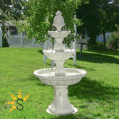 a water fountain in the middle of a lawn