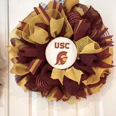 a washington state university wreath hanging on a door with the word u s c painted on it