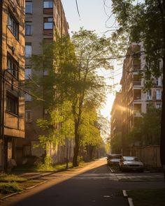 the sun is shining down on an empty city street with tall buildings in the background