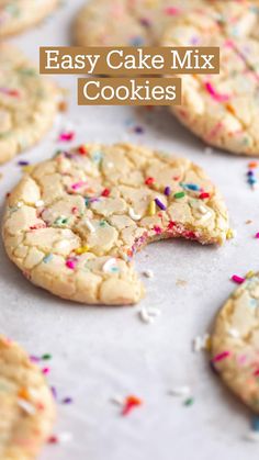 several cookies with sprinkles and one has a bite taken out of it