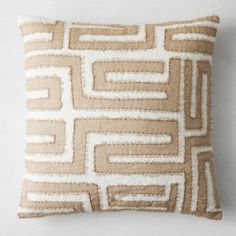 a brown and white pillow with squares on it