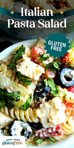 pasta salad with olives and tomatoes in a white bowl