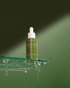 Creative product photography for Baselift hair growth serum.  Hero texture on glass shelf shot with drip of of water to display moisture.  Shot on a gorgeous olive green and shadow framing product.  Styled, shot and post product by - Gemma Wood Creative Studio  #Productphotography #glassshelf #beautyphotography #cosmeticphotography #skincarephotography Fresh Product Photography, Liquid Product Photography, Skin Serum Photography, Luxury Skincare Product Photography, Serum Photography Products, Skincare Product Shots, Macro Product Photography, Product Studio Photography, Wellness Product Photography