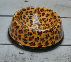 a leopard print dog bowl sitting on the ground