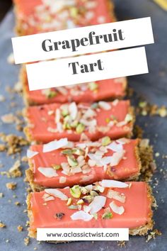 grapefruit tart with almonds and pistachio on top, sitting on a blue surface