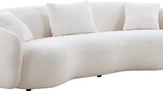 a white couch with four pillows on it's back and one arm facing the camera