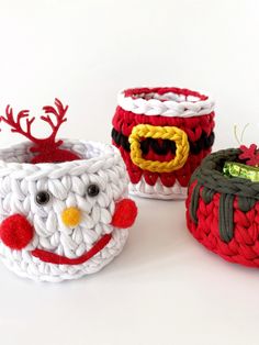 three crocheted cups with christmas decorations on them