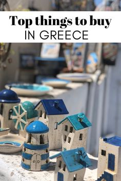 some small houses are sitting on a ledge with text overlay that reads top things to buy in greece